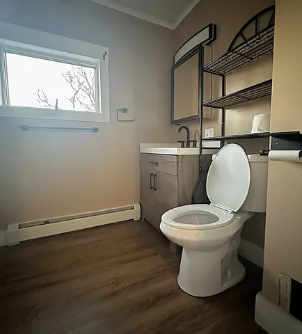 a bathroom with a toilet sink and mirror