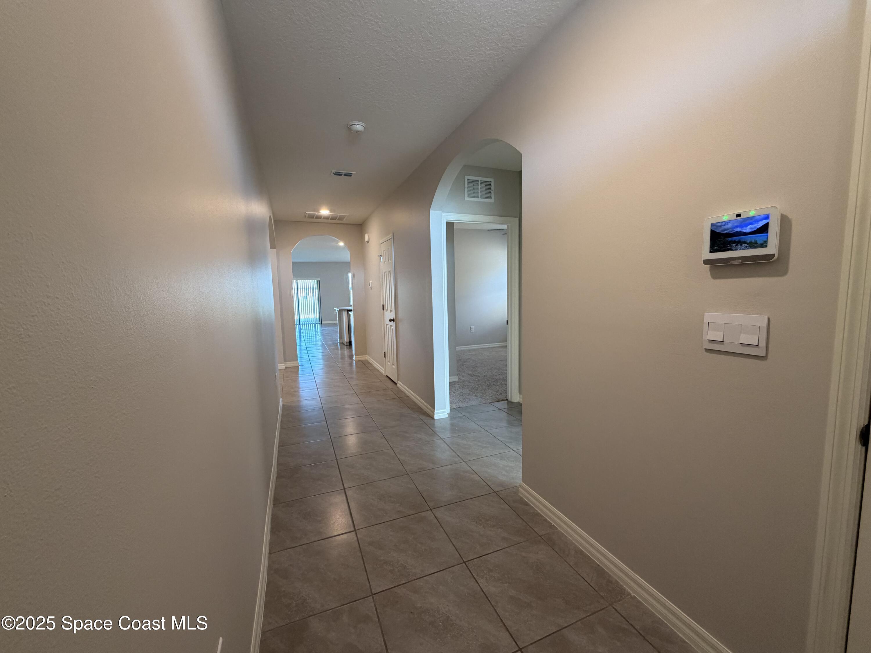 3899 Foggy Mist Road Southeast Palm Bay, FL 32909 - Photo 2 of 3 a view of hallway with a bathroom