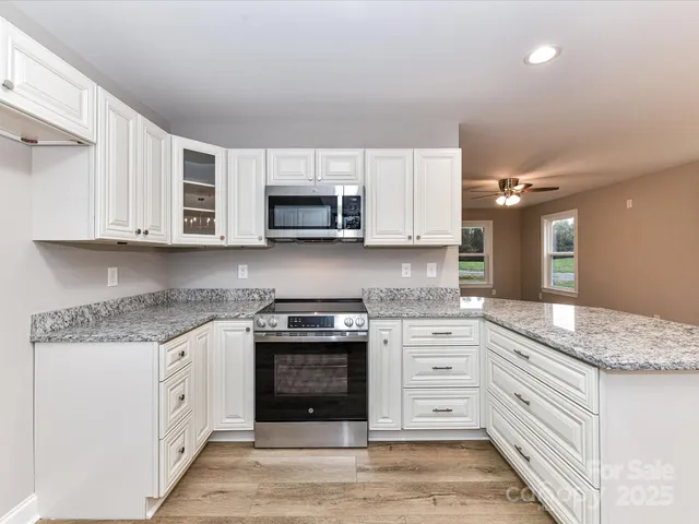 a kitchen with stainless steel appliances granite countertop a stove and a sink