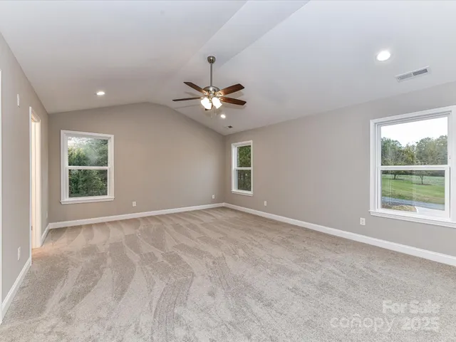 an empty room with fan and a ceiling fan