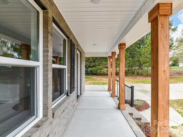 a view of a porch with wooden floor and outdoor space