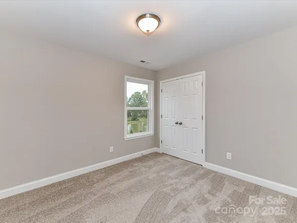 a view of a hallway with closet and wooden floor