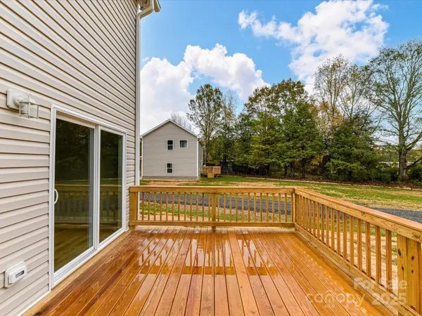 a view of a balcony with wooden floor and fence