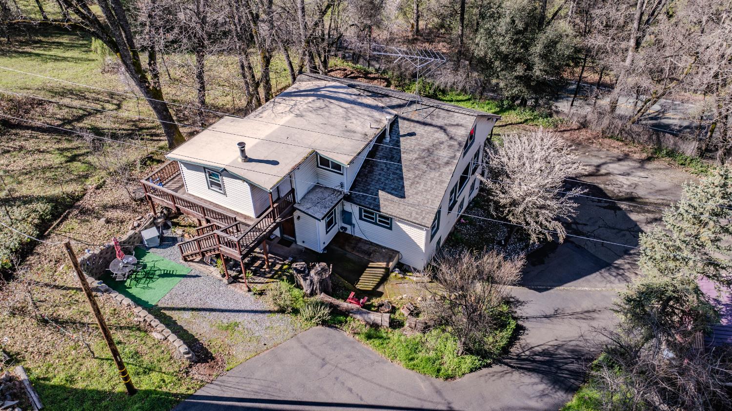 an aerial view of a house with a yard