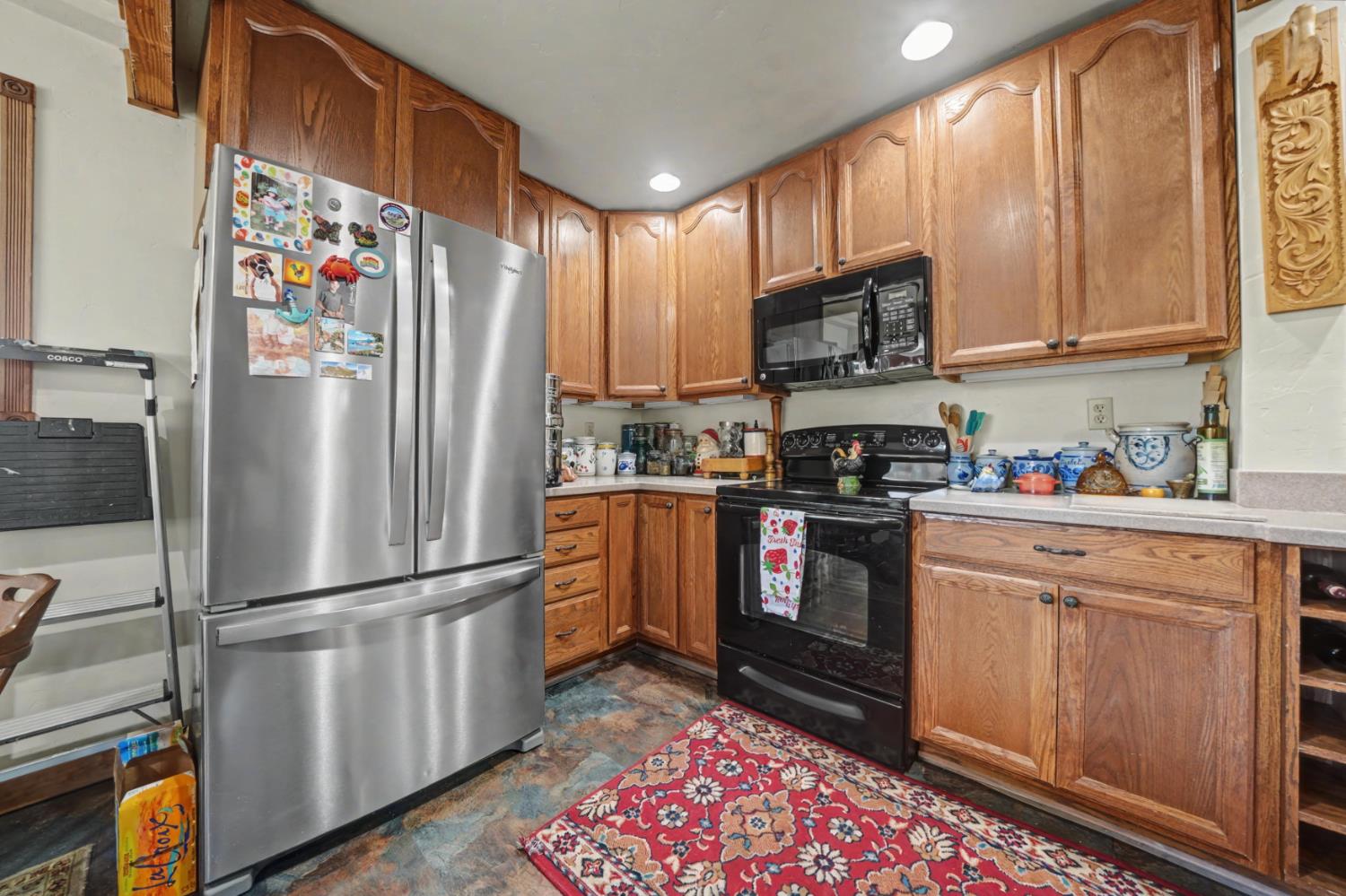 3341 Newtown Road Placerville, CA 95667 - Photo 17 of 49 a kitchen with stainless steel appliances granite countertop a refrigerator stove and microwave