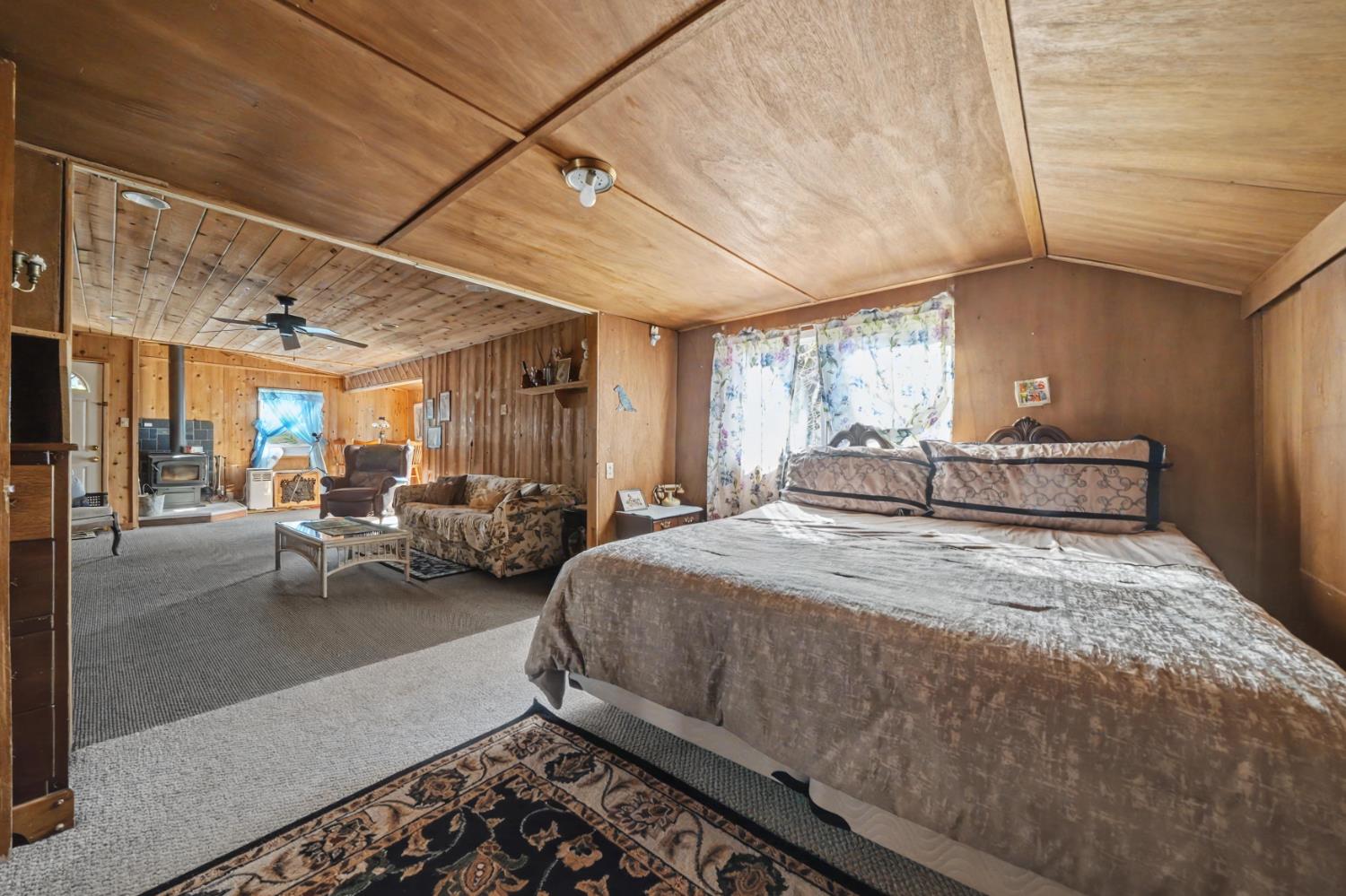 3341 Newtown Road Placerville, CA 95667 - Photo 31 of 49 a spacious bedroom with a bed mirror and a desk