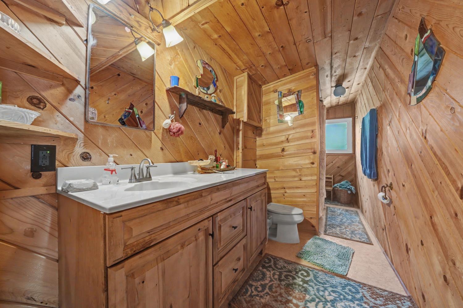 3341 Newtown Road Placerville, CA 95667 - Photo 37 of 49 a bathroom with a sink a toilet and a mirror