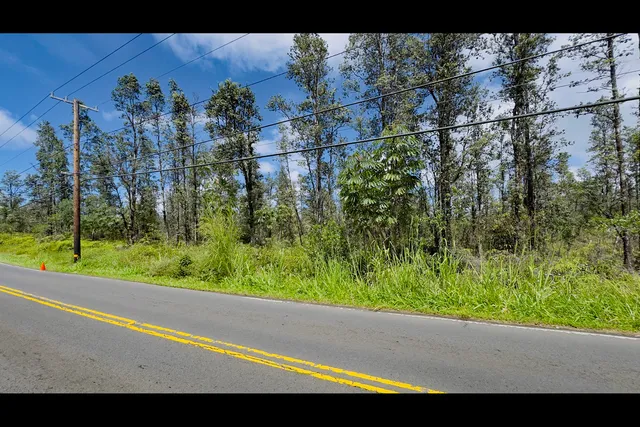 a view of a street with a building in the background