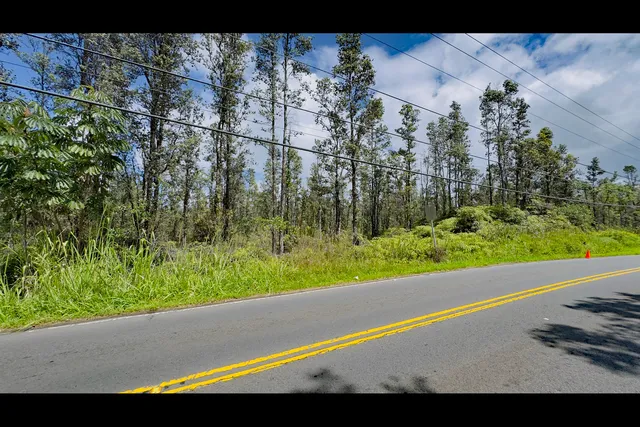 a view of a street with a large building in the background