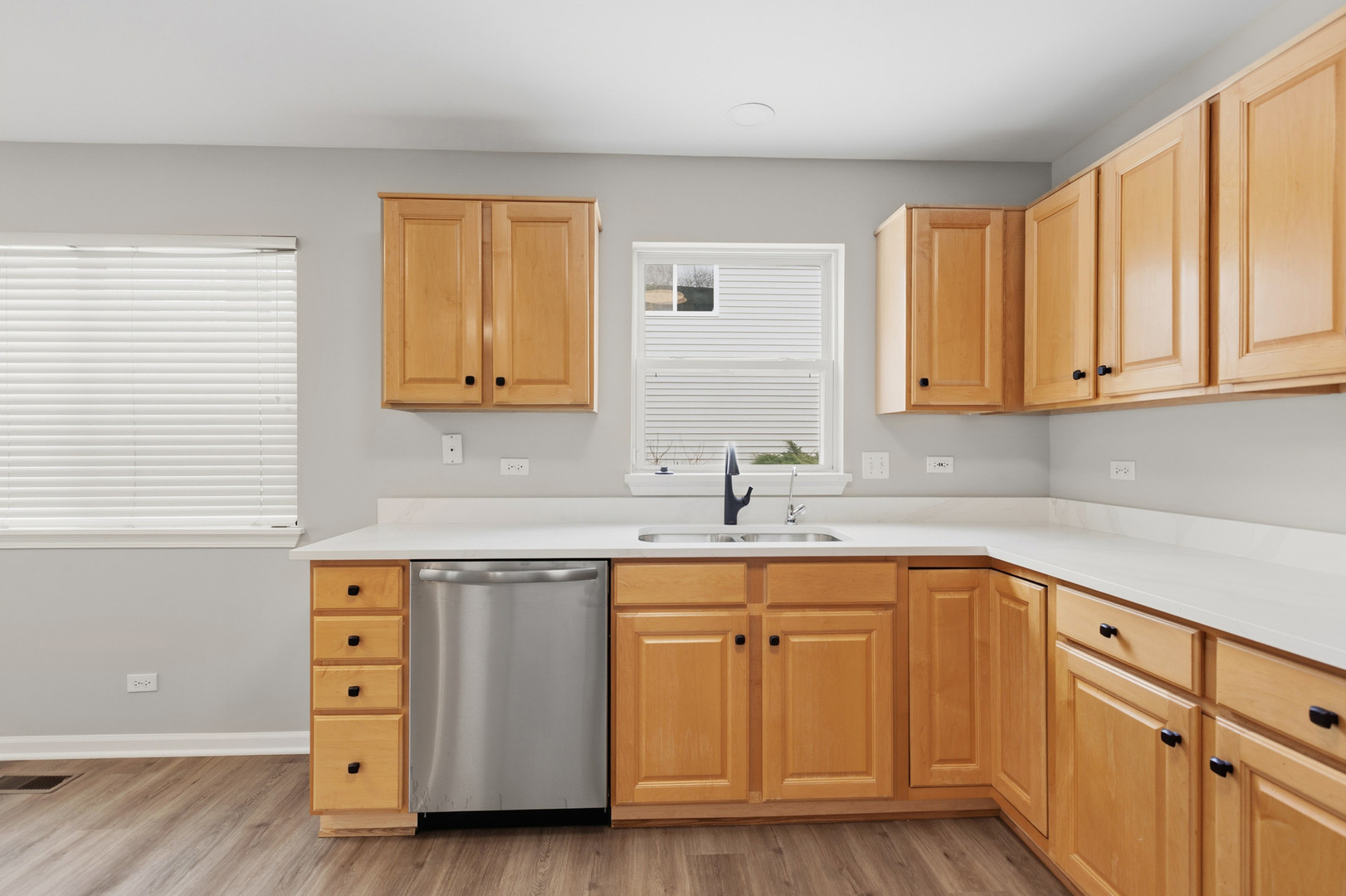 2607 Lexington Lane Naperville, IL 60540 - Photo 11 of 30 a kitchen with stainless steel appliances granite countertop a sink and cabinets with wooden floor