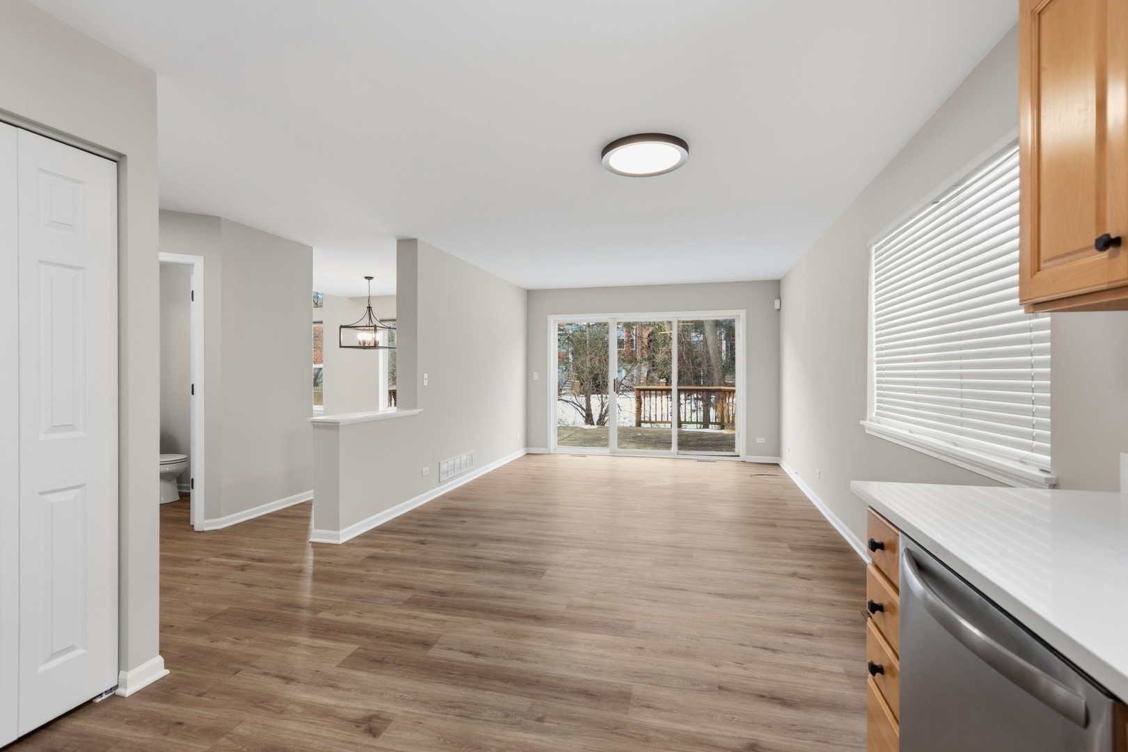 2607 Lexington Lane Naperville, IL 60540 - Photo 12 of 30 a view of an empty room with wooden floor and a window