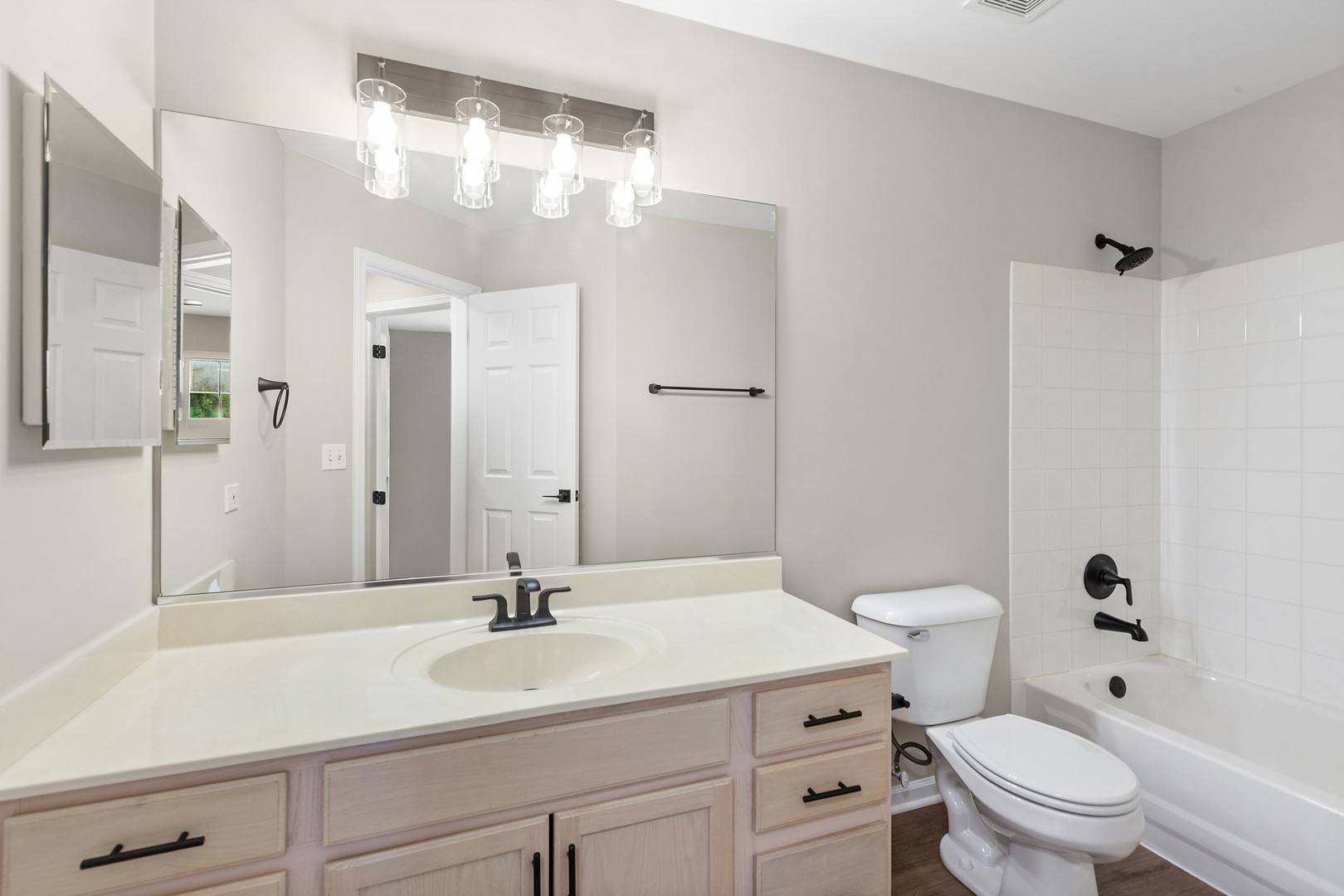 2607 Lexington Lane Naperville, IL 60540 - Photo 23 of 30 a bathroom with a sink a toilet a mirror and shower