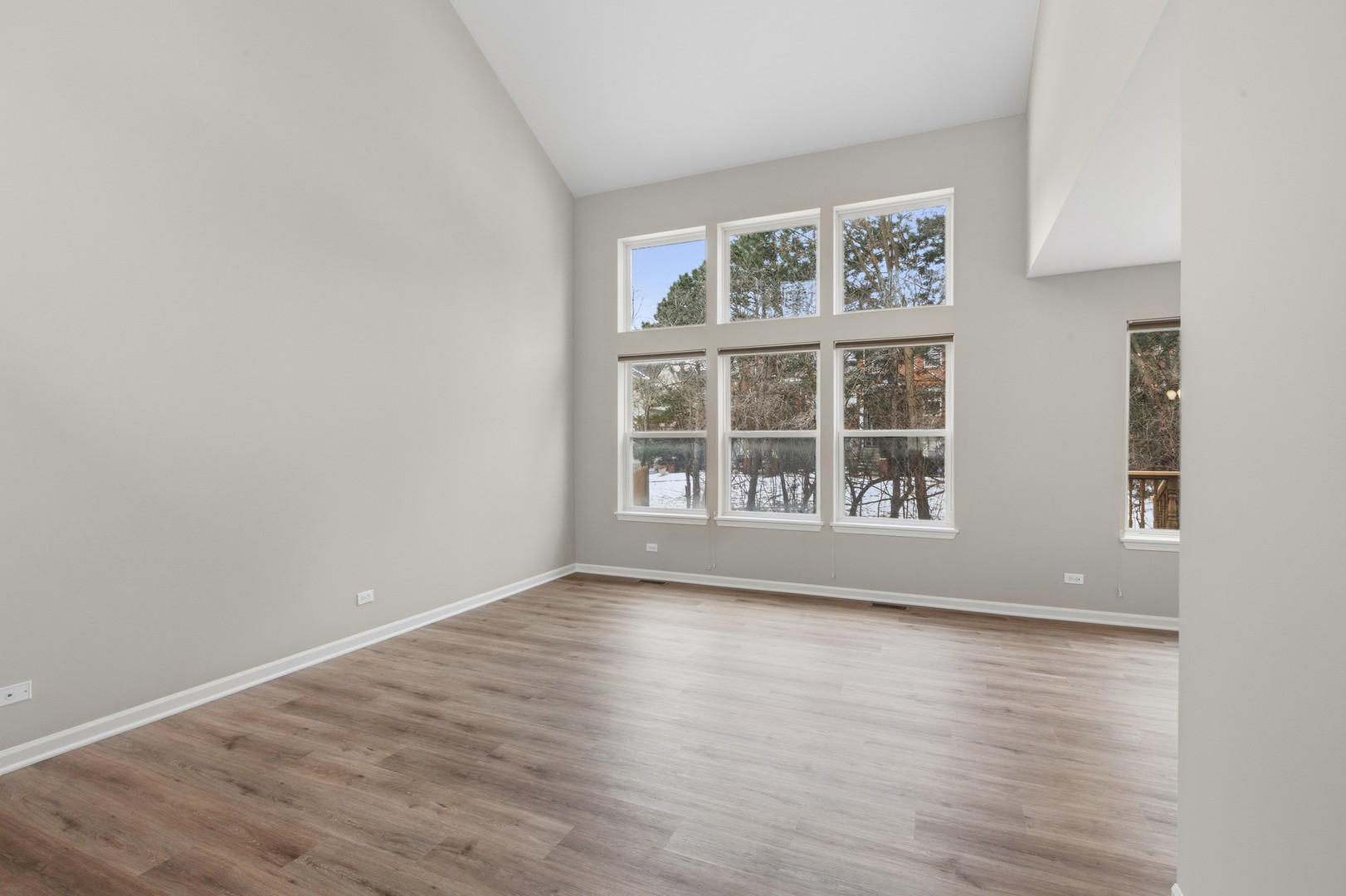 2607 Lexington Lane Naperville, IL 60540 - Photo 3 of 30 a view of an empty room with wooden floor and a window