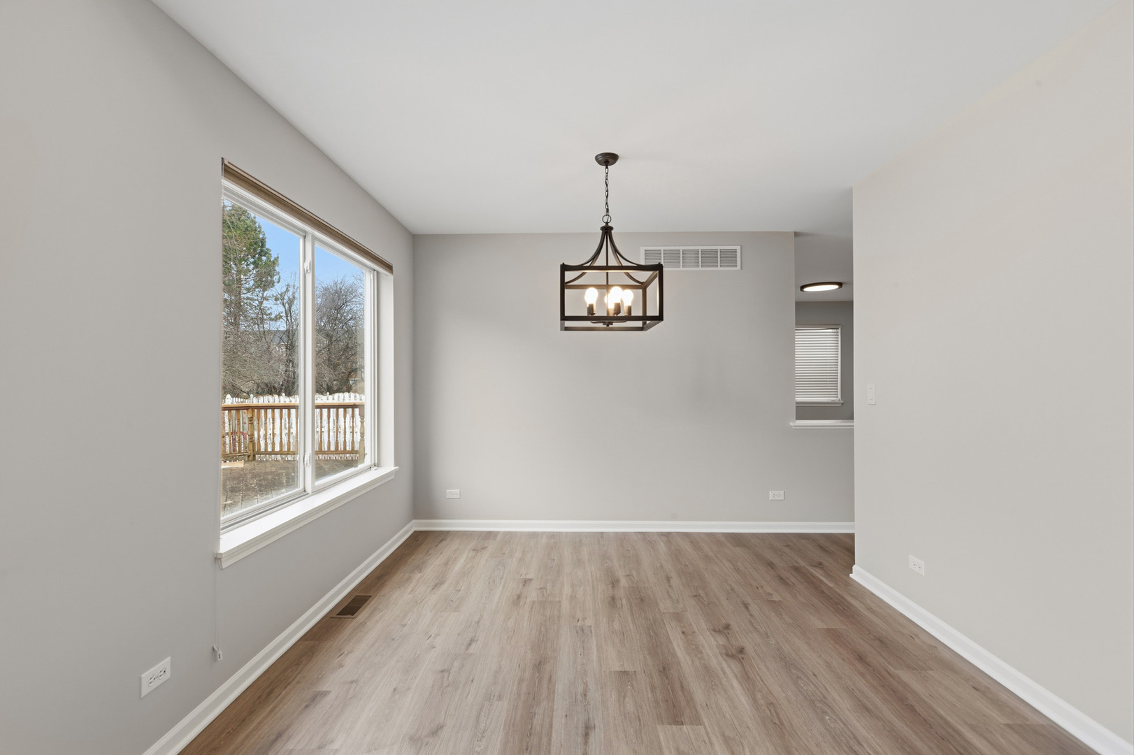 2607 Lexington Lane Naperville, IL 60540 - Photo 6 of 30 a view of a big room with wooden floor and windows
