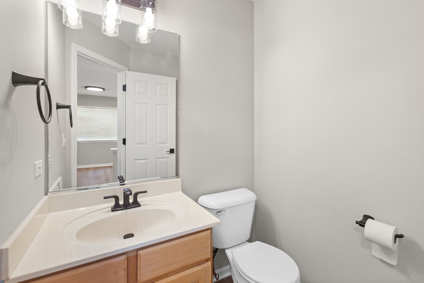 2607 Lexington Lane Naperville, IL 60540 - Photo 7 of 30 a bathroom with a sink mirror and toilet