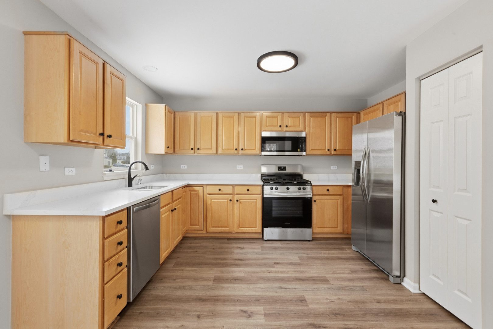 2607 Lexington Lane Naperville, IL 60540 - Photo 9 of 30 a kitchen with stainless steel appliances granite countertop a stove a sink and a refrigerator