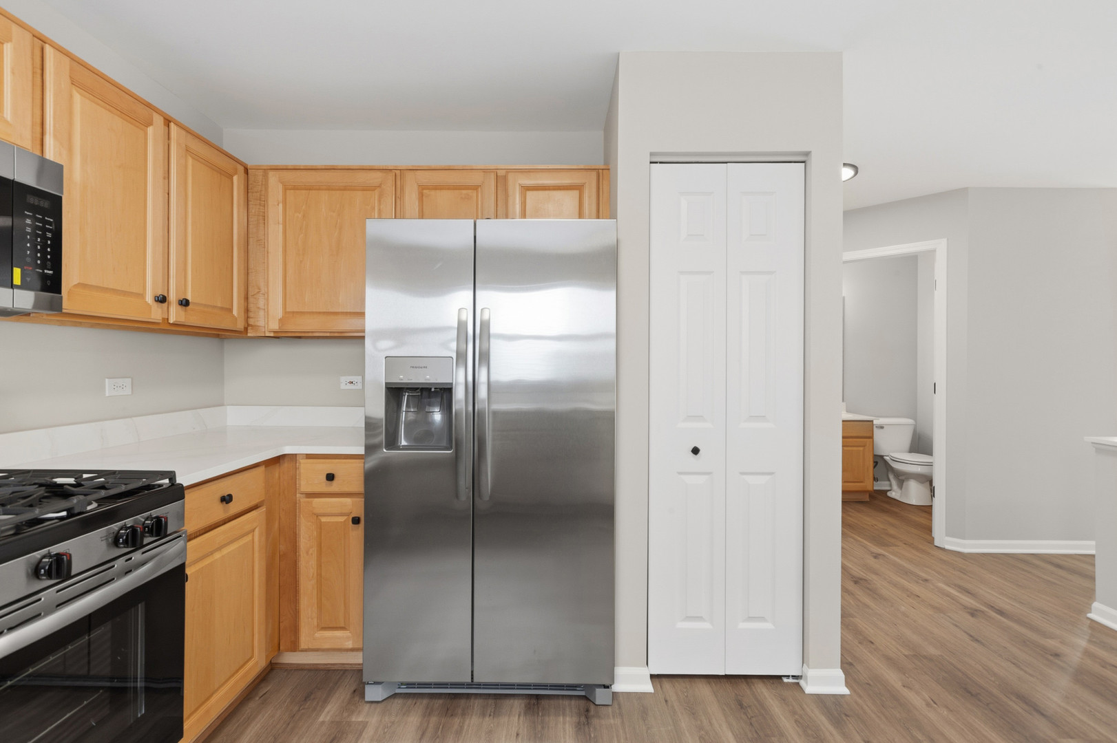 2607 Lexington Lane Naperville, IL 60540 - Photo 10 of 30 a kitchen with a refrigerator sink and cabinets