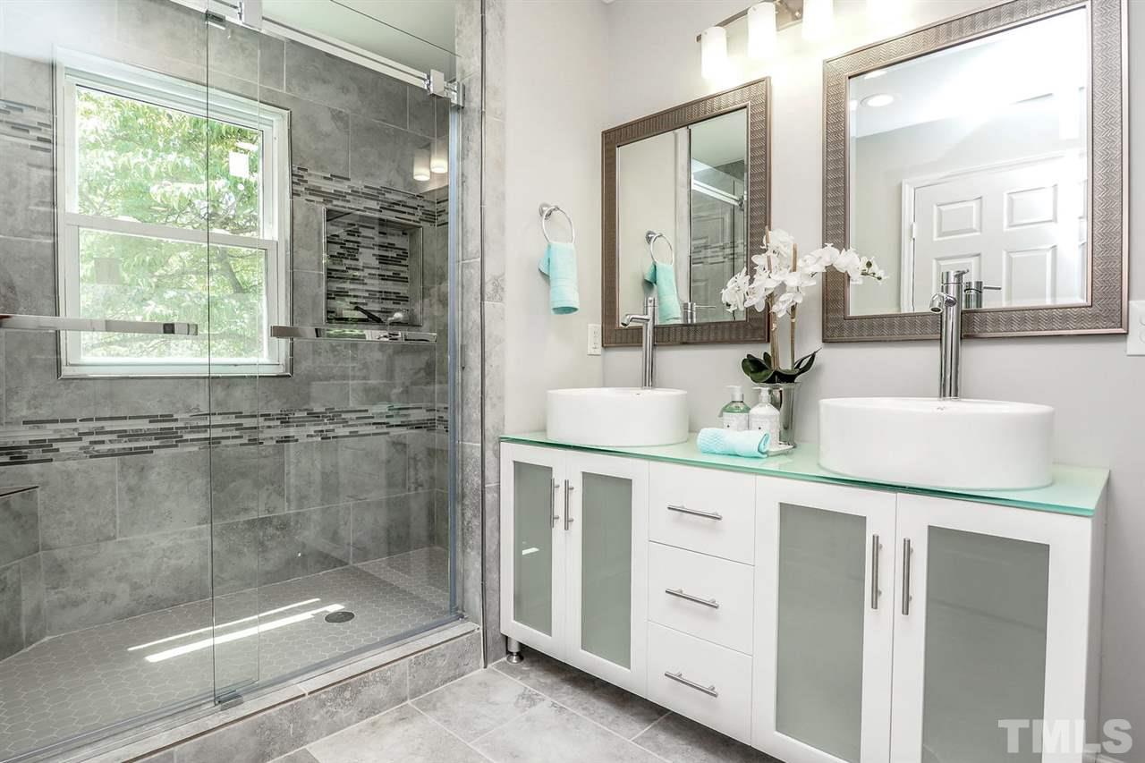 1113 Winona Road Raleigh, NC 27609 - Photo 11 of 25 a bathroom with a shower sink and mirror