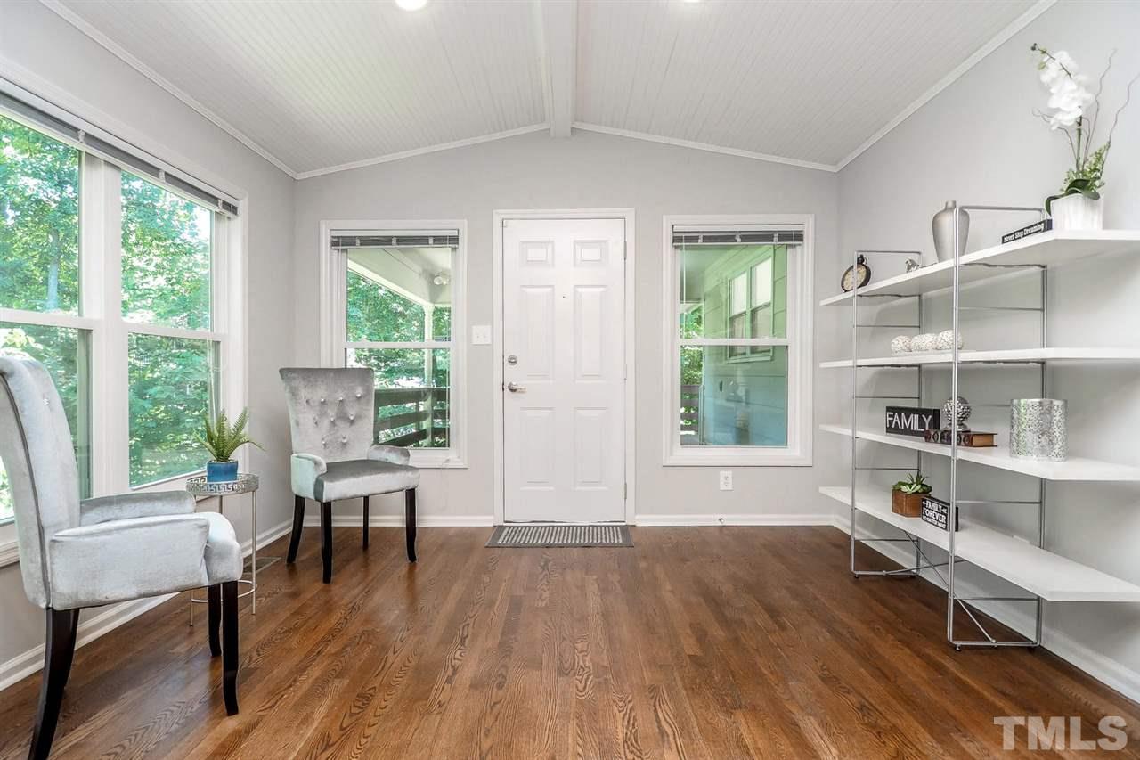 1113 Winona Road Raleigh, NC 27609 - Photo 16 of 25 a living room with furniture wooden floor and a window