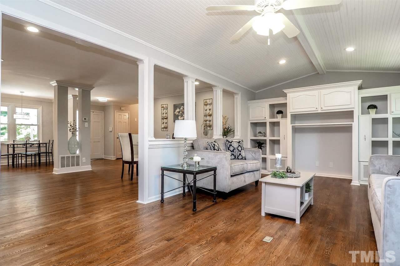 1113 Winona Road Raleigh, NC 27609 - Photo 17 of 25 a living room with fireplace furniture and a wooden floor