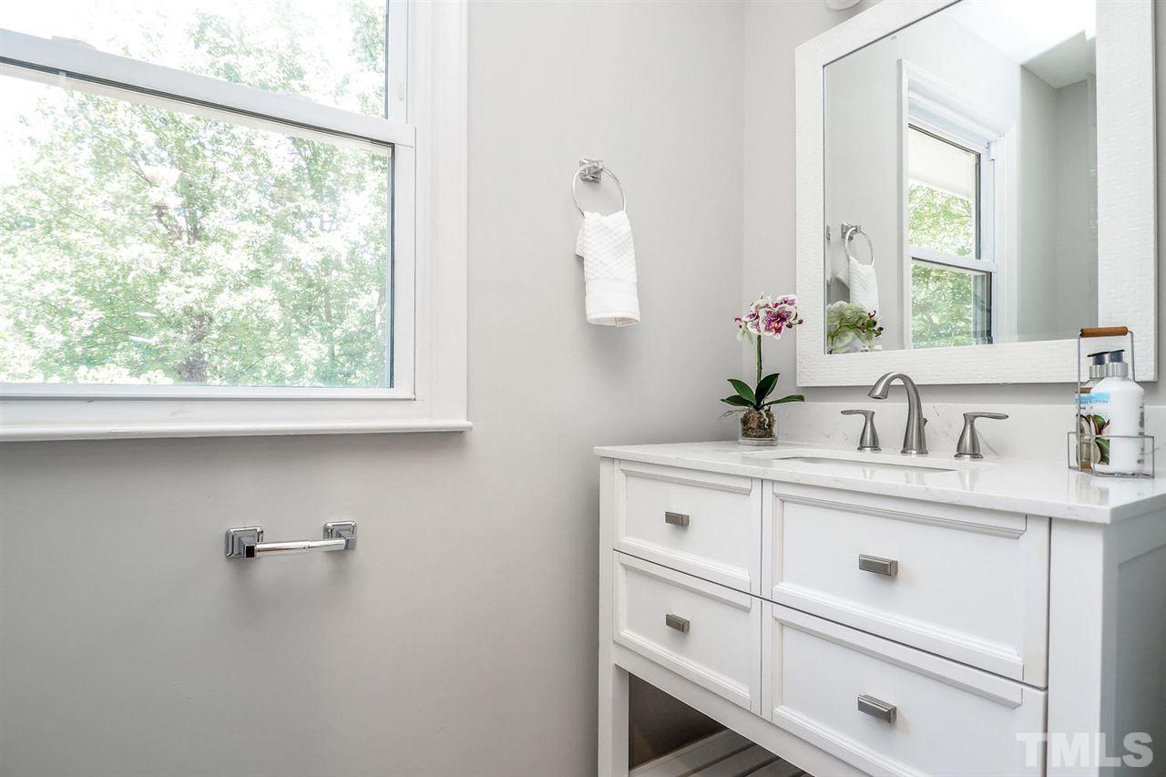 1113 Winona Road Raleigh, NC 27609 - Photo 19 of 25 a bathroom with a sink and a mirror
