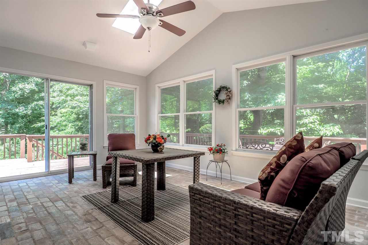 1113 Winona Road Raleigh, NC 27609 - Photo 22 of 25 a living room with furniture and large windows