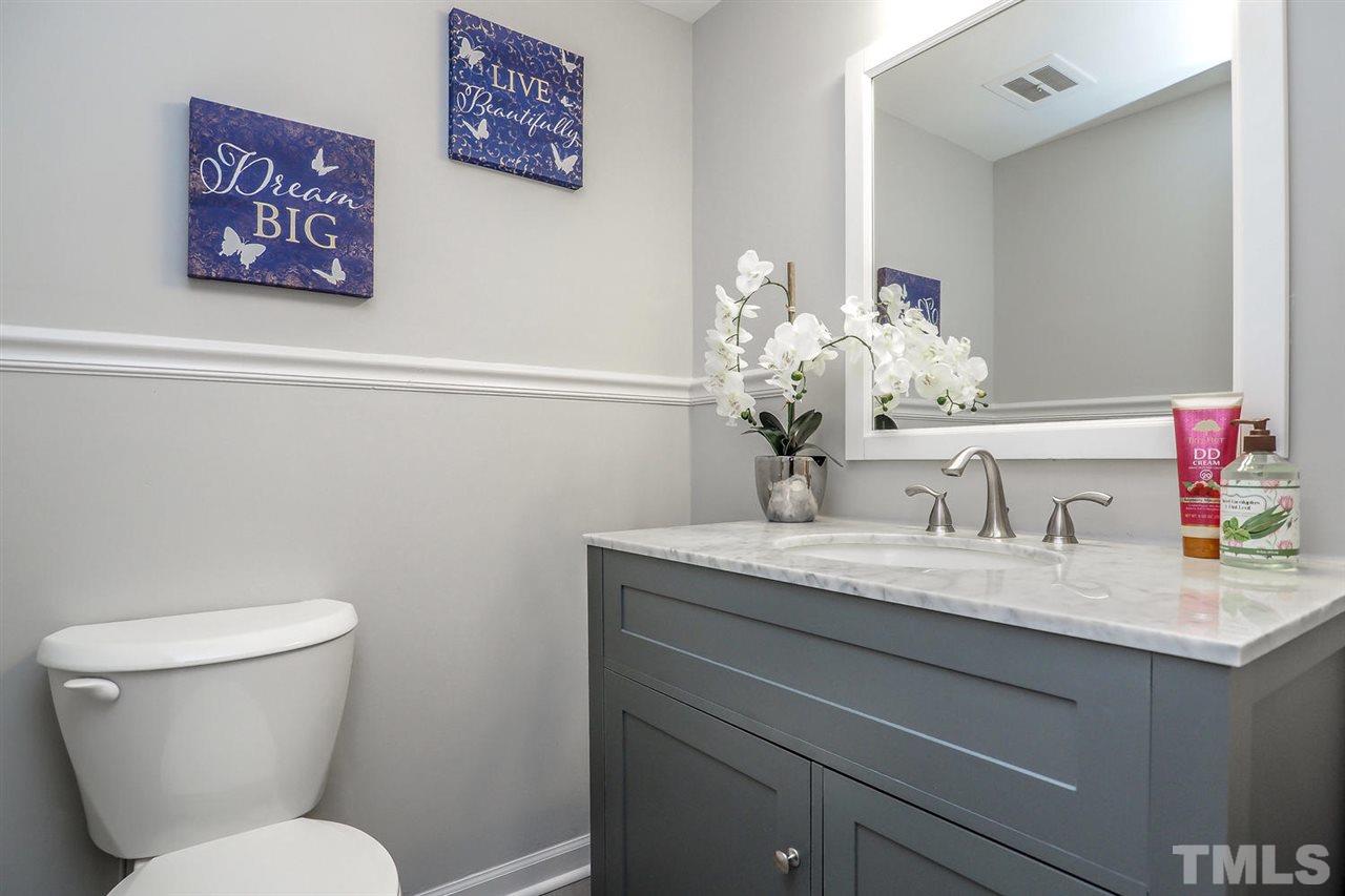 1113 Winona Road Raleigh, NC 27609 - Photo 23 of 25 a bathroom with a toilet sink and mirror