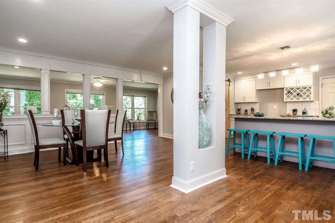 1113 Winona Road Raleigh, NC 27609 - Photo 4 of 25 a view of a dining room with furniture and wooden floor