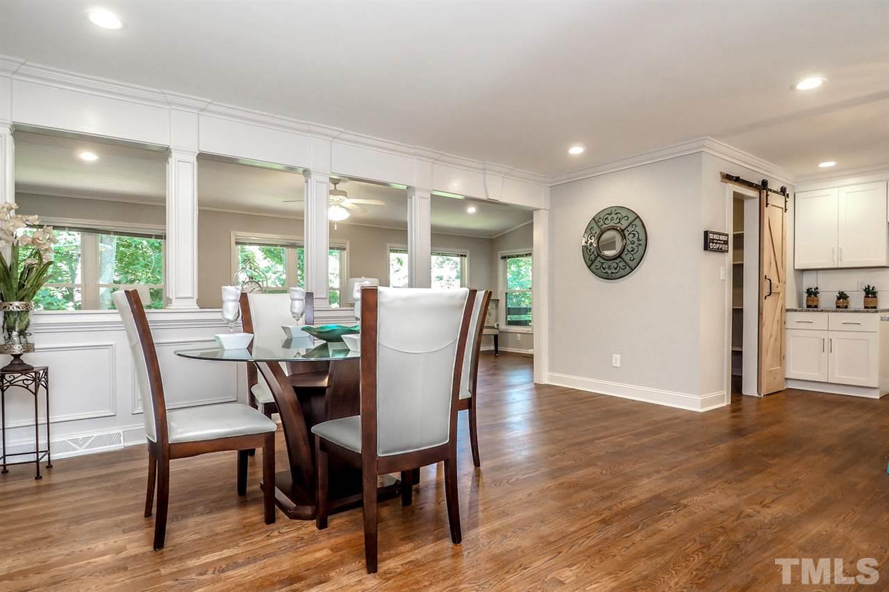 1113 Winona Road Raleigh, NC 27609 - Photo 8 of 25 a view of a dining room with furniture and wooden floor