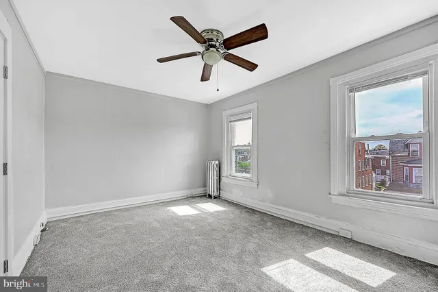 a view of room with a ceiling fan and window