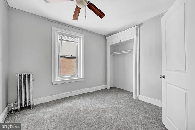an empty room with ceiling fan