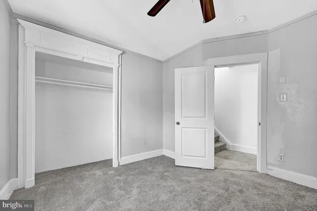 a view of room with window and ceiling fan