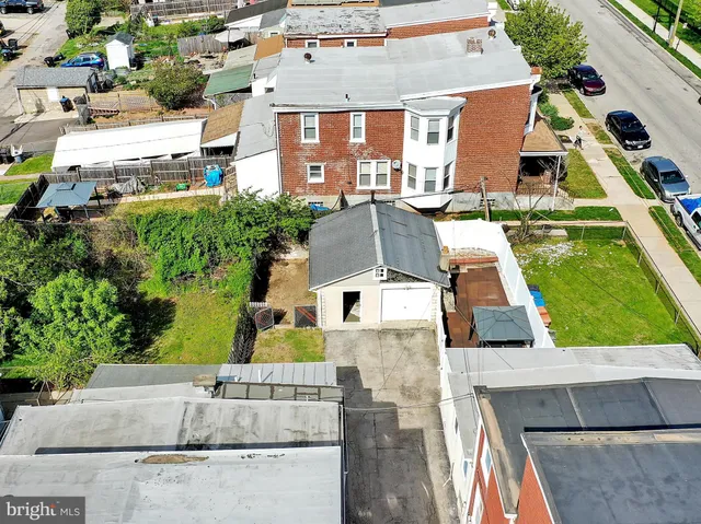 an aerial view of residential houses with outdoor space and parking