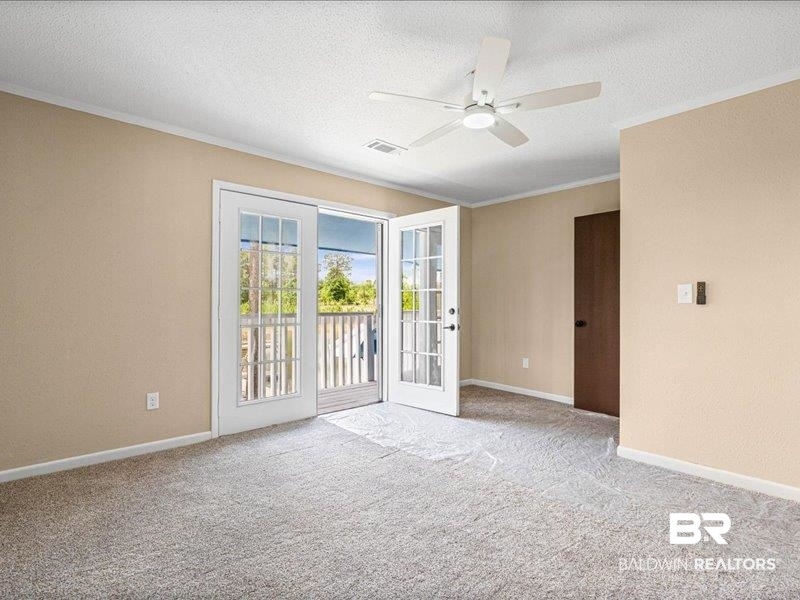3160 Old Castleberry Road Brewton, AL 36426 - Photo 14 of 36 Room featuring soft pile carpeting, neutral wall tones, and a ceiling fan with integrated lighting