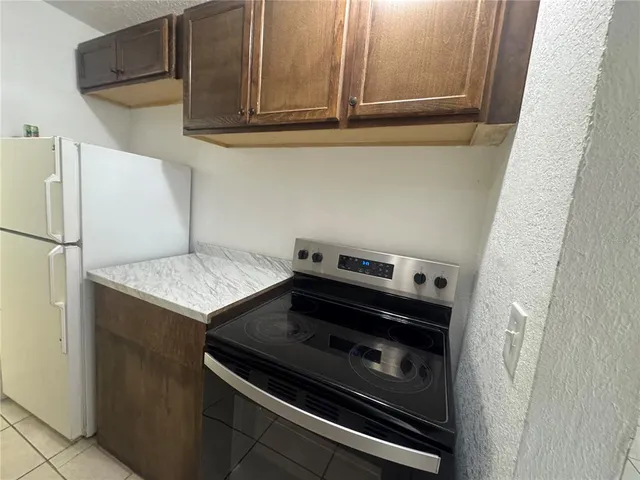 a stove top oven sitting inside of a kitchen