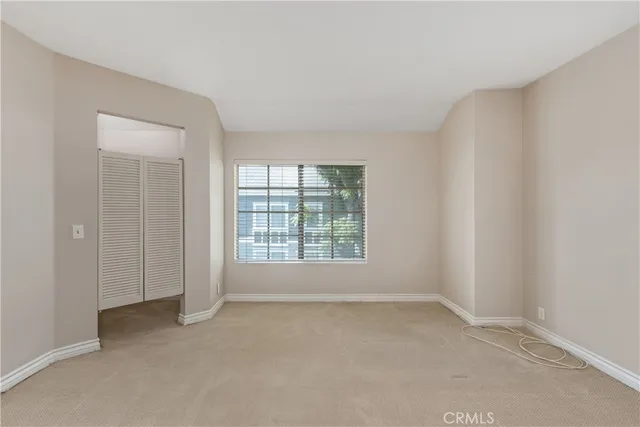 an empty room with a empty space and windows