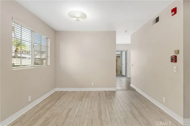 a view of wooden floor and windows in a room