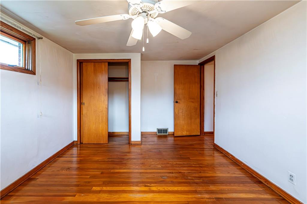 13740 Ridge Road Irwin, PA 15642 - Photo 21 of 43 a view of an empty room with window and wooden floor