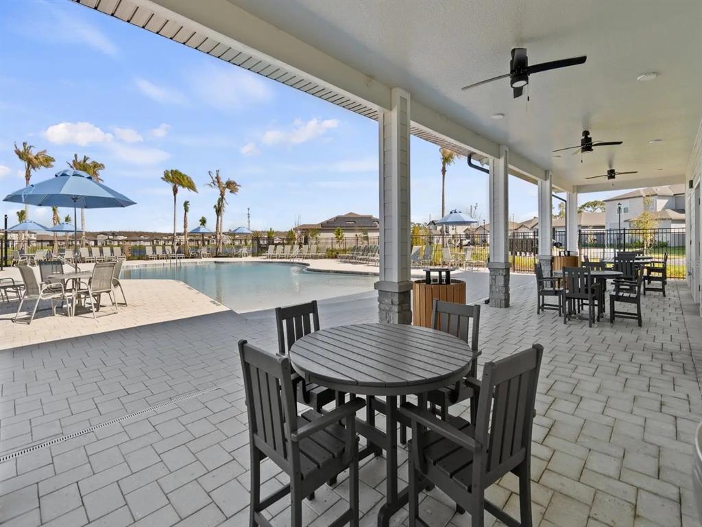 4244 Ranch House Road St. Cloud, FL 34772 - Photo 32 of 34 a view of a dining room with furniture large windows and wooden floor