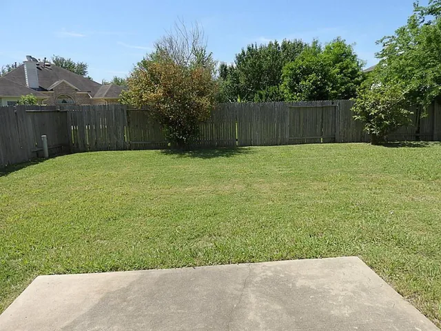 a view of a backyard with a trampoline