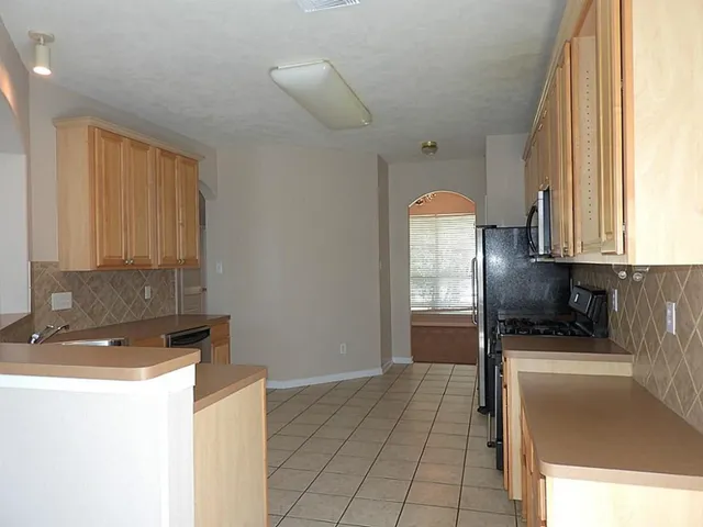 a view of a kitchen with a sink and cabinets
