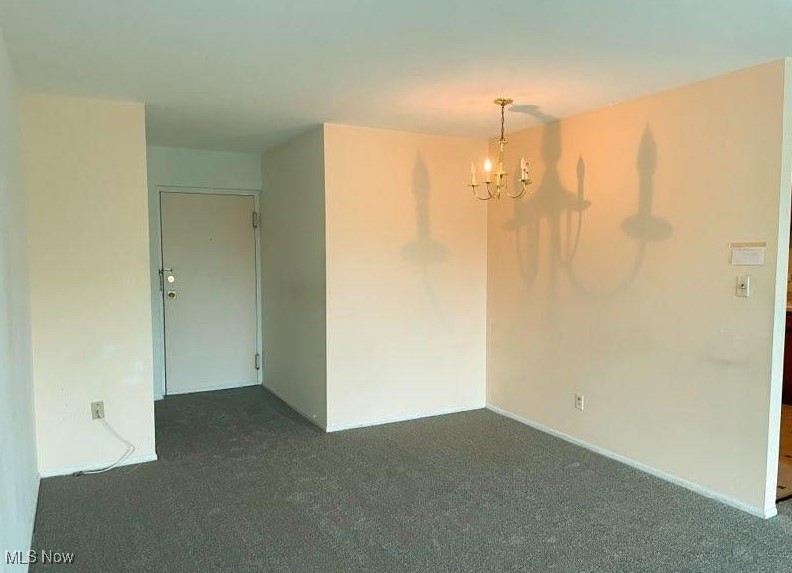 20333 Detroit Road, Unit 510B Rocky River, OH 44116 - Photo 7 of 9 Spare room with carpet flooring and a chandelier