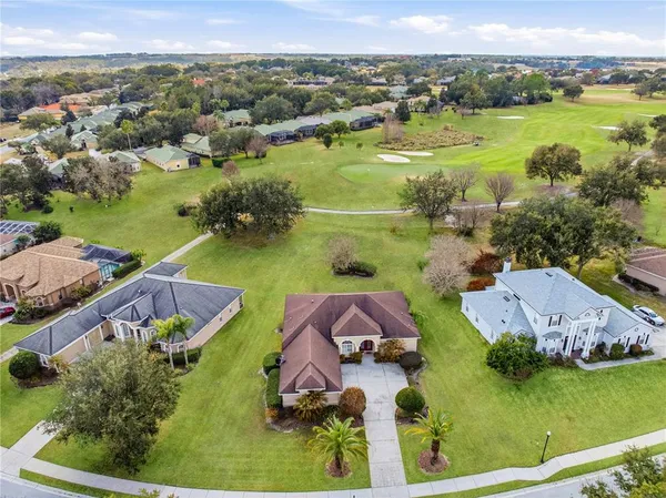 an aerial view of residential houses with outdoor space and river