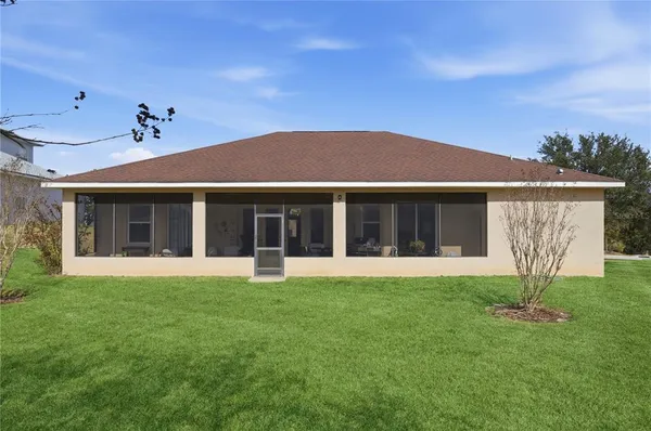 a view of a livingroom with furniture and floor to ceiling window