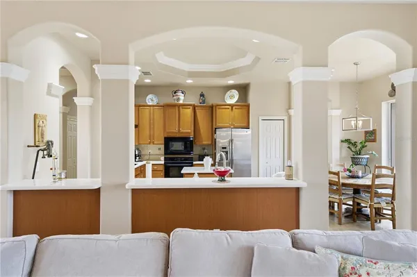 a view of a dining room with furniture and a chandelier