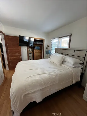 a bedroom with a bed and window