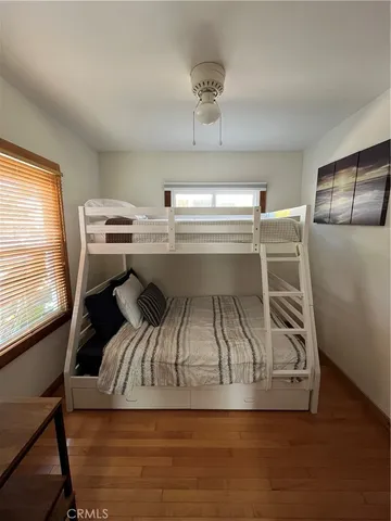 a living room with furniture a flat screen tv and a window