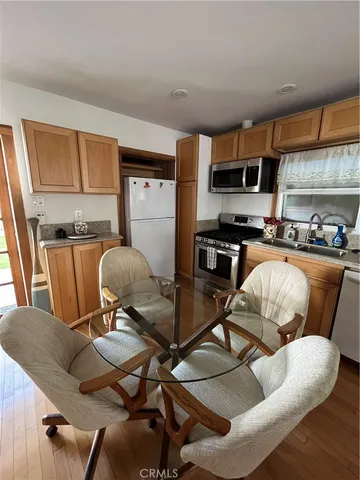 a kitchen with granite countertop a stove and a microwave