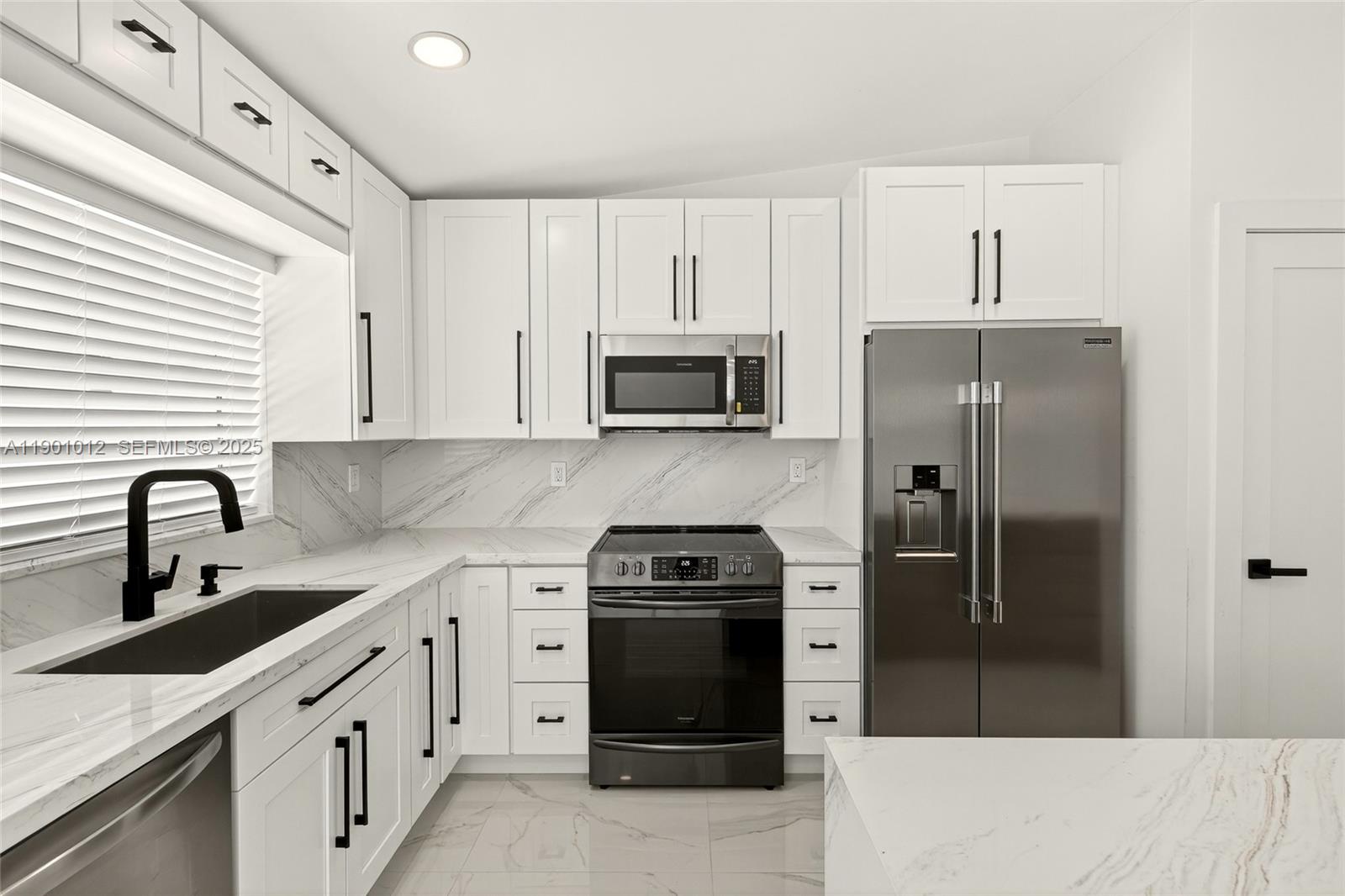 5913 Southwest 112th Terrace Cooper City, FL 33330 - Photo 3 of 31 a kitchen with a sink stove and refrigerator