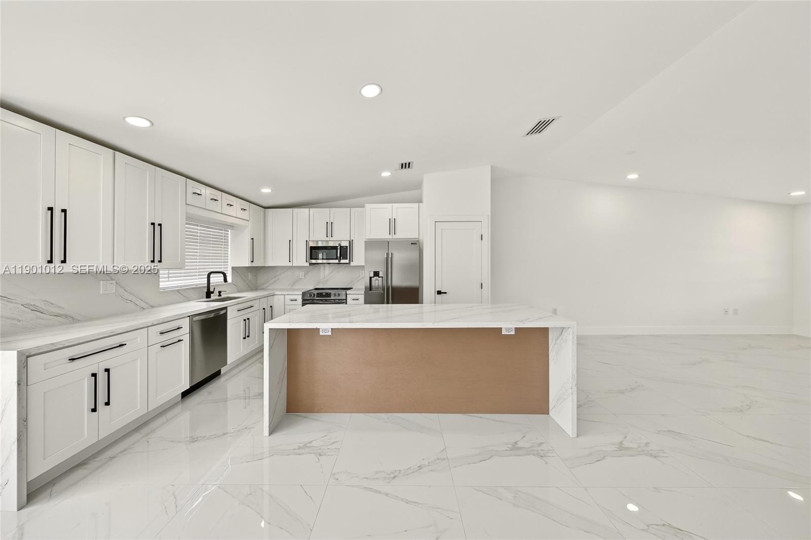 5913 Southwest 112th Terrace Cooper City, FL 33330 - Photo 4 of 31 a large white kitchen with cabinets and a sink